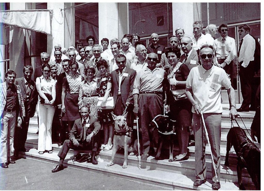Group of delegates standing on the steps of a building in 1973